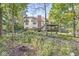 The backyard features mature landscaping, a multilevel deck and patio for entertaining, and plenty of privacy at 8425 N Halyard N Way, Indianapolis, IN 46236