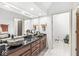 Bright bathroom featuring granite countertops, dual sinks and tile flooring, creating a functional space at 8425 N Halyard N Way, Indianapolis, IN 46236
