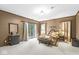 Cozy bedroom with wood trim, sliding glass doors, and neutral carpeting, providing a relaxing retreat at 8425 N Halyard N Way, Indianapolis, IN 46236