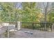 A wooden deck offers an ideal outdoor setting for relaxation, overlooking surrounding woods and nature at 8425 N Halyard N Way, Indianapolis, IN 46236