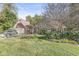 Charming brick home features a well-manicured lawn and mature trees creating a warm, inviting curb appeal at 8425 N Halyard N Way, Indianapolis, IN 46236