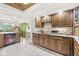 Kitchen boasts wood cabinets, tile floors, and view to outdoors at 8425 N Halyard N Way, Indianapolis, IN 46236