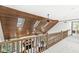 Spacious loft area with wood ceiling, skylights, railing, and view of the lower level living room at 8425 N Halyard N Way, Indianapolis, IN 46236