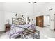 Vaulted bedroom suite boasts a ceiling fan, and double-door entry to the en suite bath at 8425 N Halyard N Way, Indianapolis, IN 46236