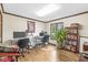 Office with hardwood floors, two desks with computers, and a large window overlooking the backyard at 8425 N Halyard N Way, Indianapolis, IN 46236