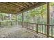 The expansive wooden patio, enclosed by railings, offers panoramic views of the surrounding trees at 8425 N Halyard N Way, Indianapolis, IN 46236