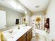 Bright bathroom with a double vanity, a sunflower shower curtain, and modern fixtures at 8729 Dorill Creek Ln, Indianapolis, IN 46259