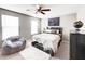 Charming bedroom with neutral decor, a comfortable bed, and plenty of natural light at 8729 Dorill Creek Ln, Indianapolis, IN 46259