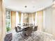 Elegant dining room with modern lighting, decorative walls, and a sleek glass dining table at 8729 Dorill Creek Ln, Indianapolis, IN 46259