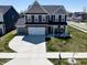 Beautiful two-story home with a well-maintained lawn and a spacious driveway at 8729 Dorill Creek Ln, Indianapolis, IN 46259