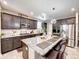 Modern kitchen featuring a large island, stainless steel appliances, and stylish lighting at 8729 Dorill Creek Ln, Indianapolis, IN 46259