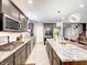 Modern kitchen with stainless steel appliances, a large island, and ample counter space at 8729 Dorill Creek Ln, Indianapolis, IN 46259