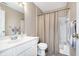 Well-maintained bathroom featuring a vanity sink, toilet, and a shower-tub combination with a curtain at 8820 Yardley Ct # 101, Indianapolis, IN 46268
