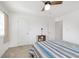 Inviting bedroom with a striped quilt, providing a serene and well-lit space with a ceiling fan at 8820 Yardley Ct # 101, Indianapolis, IN 46268