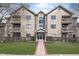Inviting exterior view of a multi-story condo building with balconies, well-maintained landscaping, and clearly marked address at 8820 Yardley Ct # 101, Indianapolis, IN 46268