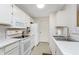 Well-equipped kitchen features stainless steel sink, white cabinets, and marble countertops at 8820 Yardley Ct # 101, Indianapolis, IN 46268