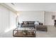 Comfortable living room featuring a large leather sectional couch, glass coffee table, and sliding glass doors for ample light at 8820 Yardley Ct # 101, Indianapolis, IN 46268