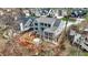 Aerial view of the home with a deck and landscaped backyard surrounded by mature trees and a natural landscape at 908 Oak Terrace Rd, Westfield, IN 46074