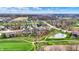Expansive aerial view captures a golf course community with ponds and upscale homes amidst lush greenery and winding streets at 908 Oak Terrace Rd, Westfield, IN 46074
