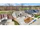 Aerial view showcases home's landscaped grounds and proximity to surrounding neighborhood and golf course at 908 Oak Terrace Rd, Westfield, IN 46074