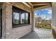 Covered back deck with a brick wall and window and a scenic view of the backyard at 908 Oak Terrace Rd, Westfield, IN 46074