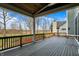 Back deck with wood railing offering wooded backyard views and covered structure at 908 Oak Terrace Rd, Westfield, IN 46074