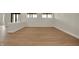 An open basement space featuring wood flooring and natural light from egress windows at 908 Oak Terrace Rd, Westfield, IN 46074
