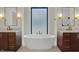 Bright bathroom with double vanities, a standalone tub, and a frosted window providing natural light and privacy at 908 Oak Terrace Rd, Westfield, IN 46074