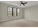 A well-lit bedroom featuring a large window with a view and neutral carpeting at 908 Oak Terrace Rd, Westfield, IN 46074