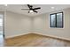 This bedroom has light-colored walls, modern ceiling fan, hardwood floors, and a window for natural light at 908 Oak Terrace Rd, Westfield, IN 46074