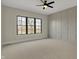 Neutral bedroom with decorative trim, large window, and a ceiling fan at 908 Oak Terrace Rd, Westfield, IN 46074