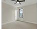 Bright bedroom with neutral carpet, a modern ceiling fan, and a window paired with a white door at 908 Oak Terrace Rd, Westfield, IN 46074