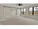 Bright bonus room with large windows, sliding doors, carpeted floors and a ceiling fan at 908 Oak Terrace Rd, Westfield, IN 46074
