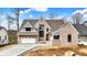 Beautiful new construction home with a brick facade, multi-car garage, and manicured landscaping at 908 Oak Terrace Rd, Westfield, IN 46074