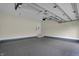 An expansive garage with epoxy flooring and overhead lighting at 908 Oak Terrace Rd, Westfield, IN 46074
