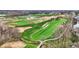 Scenic aerial view of a golf course community, featuring rolling greens, mature trees, and tranquil water features at 908 Oak Terrace Rd, Westfield, IN 46074