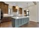 Island kitchen with marble countertops, pendant lighting, stainless steel appliances and view to eating area at 908 Oak Terrace Rd, Westfield, IN 46074