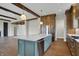 Kitchen island featuring bar seating and stainless dishwasher, with view to the living room at 908 Oak Terrace Rd, Westfield, IN 46074