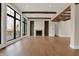 Stylish living room with hardwood floors, a cozy fireplace, and large windows overlooking the outdoor deck and yard at 908 Oak Terrace Rd, Westfield, IN 46074