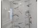 Close up of a modern shower with a chrome shower head and marble tile surround at 908 Oak Terrace Rd, Westfield, IN 46074