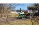 Cozy backyard featuring a swing, black bench, and brick-lined garden ready for spring planting at 9161 Warwick Rd, Indianapolis, IN 46240