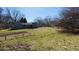 Spacious backyard with a garden, lawn, and trees creating a private outdoor space at 9161 Warwick Rd, Indianapolis, IN 46240
