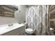 Bathroom featuring decorative wood accent wall, vanity and toilet at 9161 Warwick Rd, Indianapolis, IN 46240