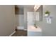 Bright bathroom features modern vanity, updated fixtures, and a full bathtub with tiled surround at 9161 Warwick Rd, Indianapolis, IN 46240