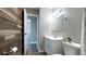 Bathroom featuring decorative wood accent wall and modern vanity at 9161 Warwick Rd, Indianapolis, IN 46240