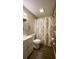 Well-maintained bathroom with wood-look flooring, a decorative shower curtain, and updated vanity at 9161 Warwick Rd, Indianapolis, IN 46240