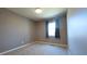 Neutral bedroom with beige carpet, window, and warm-toned walls at 9161 Warwick Rd, Indianapolis, IN 46240