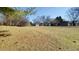 Expansive front yard with mature trees and a charming home in the background at 9161 Warwick Rd, Indianapolis, IN 46240