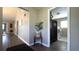 Hallway with wood floors, leading to a laundry room with modern appliances at 9161 Warwick Rd, Indianapolis, IN 46240