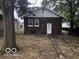 Brick exterior with a white door and two windows overlooking the lawn in the backyard at 923 N Denny St, Indianapolis, IN 46201